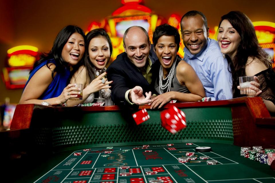 A group of people at a casino Description automatically generated with medium confidence