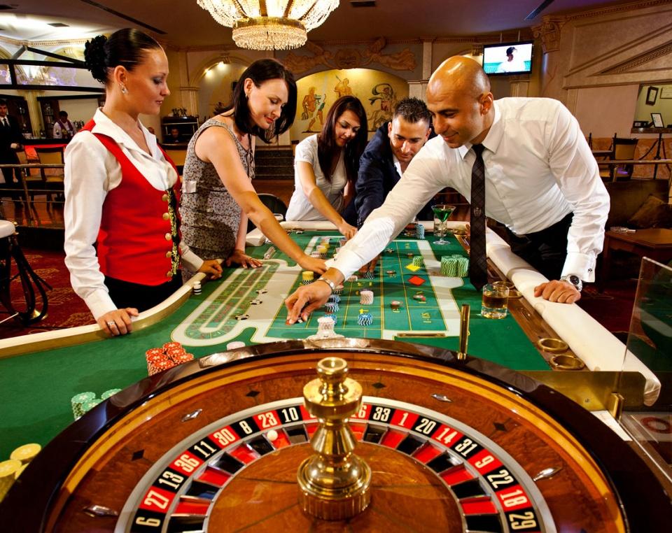 A group of people playing roulette Description automatically generated